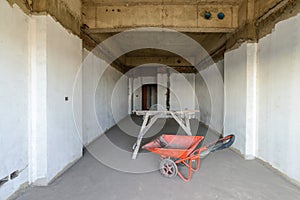 Wheel barrow and scaffolding at construction site