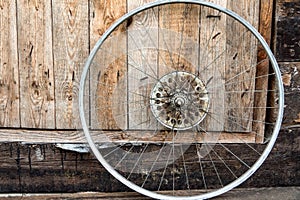 Wheel from a bicycle on a wooden background