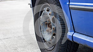 Wheel of a blue car close up