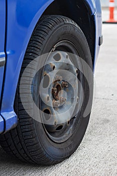 Wheel of a blue car close up