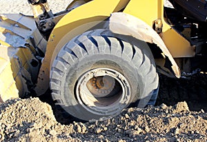 Wheel bulldozer machine for shoveling sand at eathmoving works in construction site