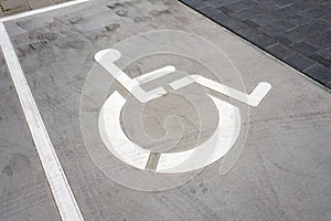 Wheel chair symbol on a parking place.