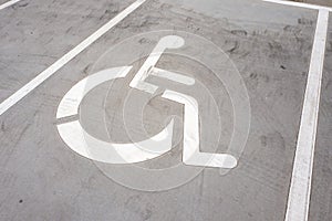 Wheel chair symbol on a parking place.