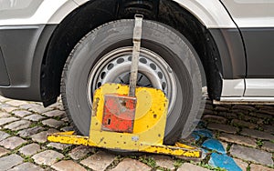 Wheel Clamp on a Poorly Parked Car without Authorization, Blue Zone for Residents Only