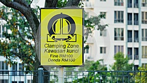 Wheel clamping warning sign