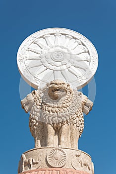 Wheel of Dhamma or Wheel of Law or Wheel of Life on blue sky background in Thailand. photo