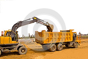 Wheel excavator and dump truck with white background, wheel excavator in construction site, soil