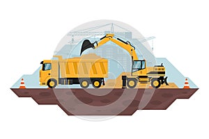 Wheel excavator filling a dump truck, heavy machinery used in the construction and mining industry. safety cones