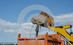 Wheel excavator loading gravel in the truck