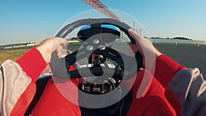 Wheel of a go-cart being controlled by a racer