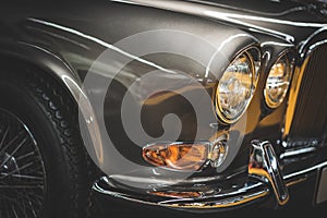 Wheel, grille and headlamps of a classic car