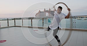 Wheel gymnastics with the view on Atlantis hotel in Dubai, sports athlete, 4k