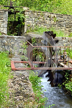 Wheel with iron water pulling a generator.