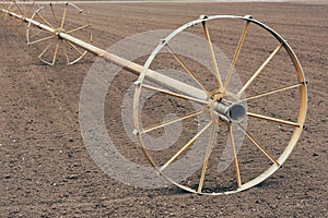 Wheel line irrigation equipment in ploughed field