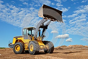 Wheel loader bulldozer in sandpit photo