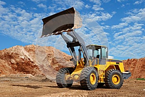 Wheel loader bulldozer in sandpit photo