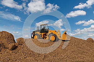 Wheel loader are digging the soil in the construction site