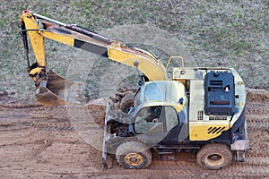 A wheel loader digs the ground at a construction site to pave a road