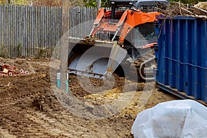 Wheel loader excavator with backhoe unloading clay