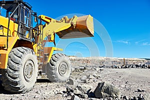 Wheel loader excavator at granite or iron ore opencast mine