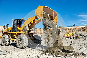 Wheel loader excavator at granite or iron ore opencast mine