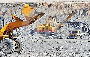 Wheel loader excavator at granite or iron ore opencast mine