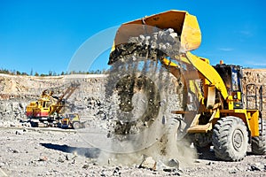 Wheel loader excavator at granite or iron ore opencast mine