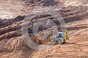 Wheel loader excavator machine working in construction site. wheel loader at sandpit during earthmoving works
