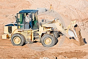 Wheel loader excavator unloading sand