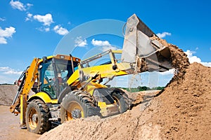 Wheel loader excavator unloading sand