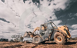 Wheel loader excavator works at construction site