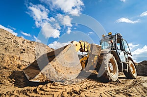 Wheel loader excavator works at construction site