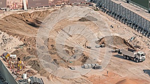 Wheel loader machine unloading sand at eathmoving works in construction site timelapse