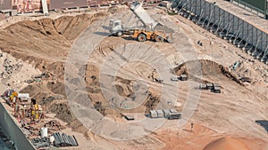 Wheel loader machine unloading sand at eathmoving works in construction site timelapse