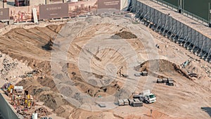 Wheel loader machine unloading sand at eathmoving works in construction site timelapse