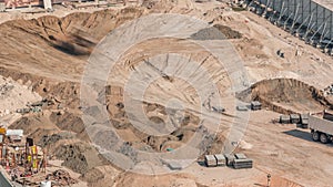 Wheel loader machine unloading sand at eathmoving works in construction site timelapse