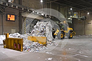 Wheel loader transports waste paper for recycling in a mill - pa