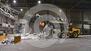 Wheel loader transports waste paper for recycling in a mill - pa