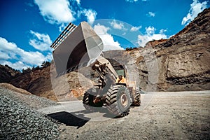 Wheel loader working at gravel during mining ore operations