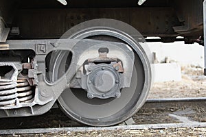 wheel mechanism of modern train locomotive on tracks. Steampunk, techno concept. Railroad transport, steel constructions