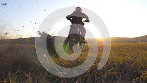 Wheel of motocross bike starting to spin and kicking up ground or dirt. Motorcycle beginning the movement. Motorcyclist
