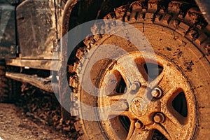 Wheel of offroad car in a muddy roadn forest