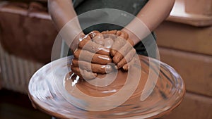 Wheel potter hand clay shaping or sculpting. Close up hands pottery wheel pot clay potter child craft. Ceramic artist