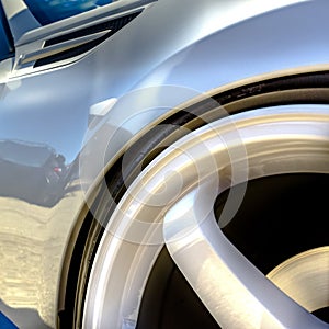 Wheel rim with white spokes on a shiny white car