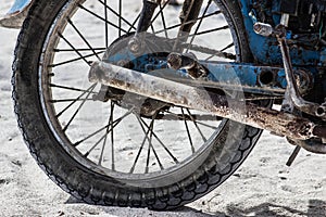 Motorcycle tire rusty on the sand blue and white photo