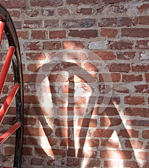 Wheel and Spokes Shadow on Wall