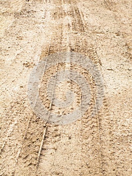 Wheel track of car on dry and cracked soil road