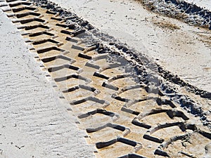 Wheel tracks on country road sand