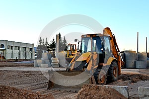 Wheel tractor excavator loader with bucket at construction works in industrial site or sandpit quarry