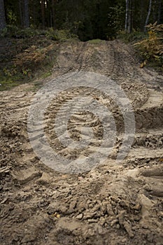 Wheel trail on sandy ground from large transport, tractor on construction site, sandy road